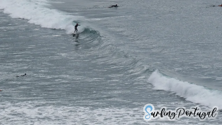 Surfer taking a left wave at Arrifana