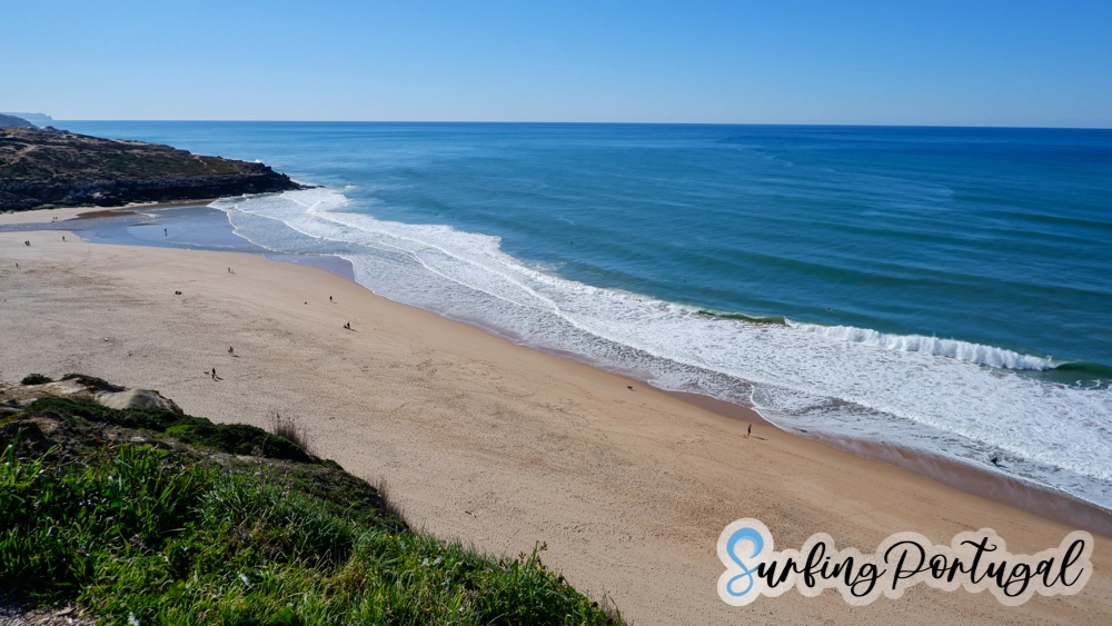View of the whole bay of Foz de Lizandro on a sunny day and with some small waves breaking